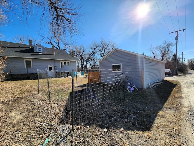 rear view of property featuring fence