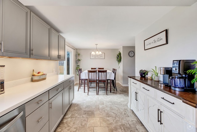 1565 Beaverhead Rd, Helena, MT 59602 - kitchen featuring dishwasher, a chandelier, stone finish floors, gray cabinetry, and baseboards