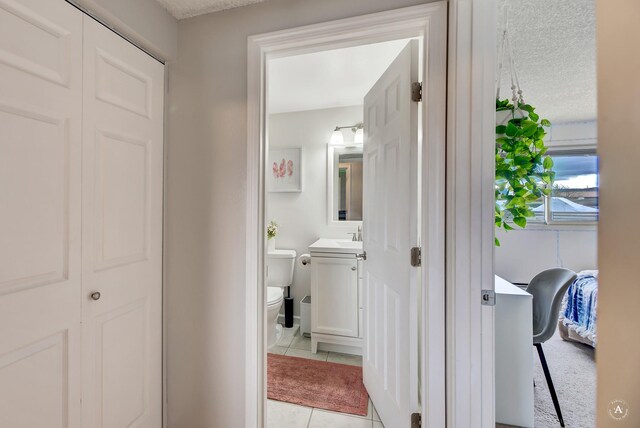 1565 Beaverhead Rd, Helena, MT 59602 - bathroom featuring toilet, tile patterned flooring, vanity, and a textured ceiling