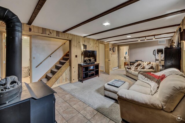 1565 Beaverhead Rd, Helena, MT 59602 - living room with beamed ceiling, light tile patterned flooring, wood walls, stairway, and a baseboard heating unit