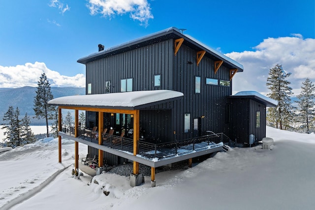 85 Meadows Dr, Whitefish, MT 59937 - snow covered back of property featuring board and batten siding and a deck