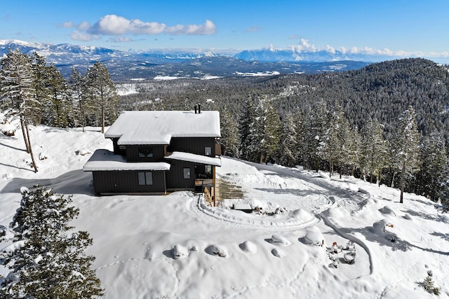 85 Meadows Dr, Whitefish, MT 59937 - snowy aerial view featuring a forest view and a mountain view