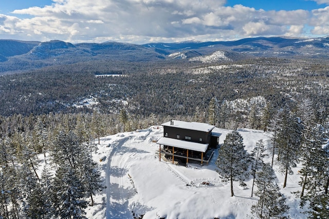 85 Meadows Dr, Whitefish, MT 59937 - snowy aerial view featuring a mountain view and a wooded view