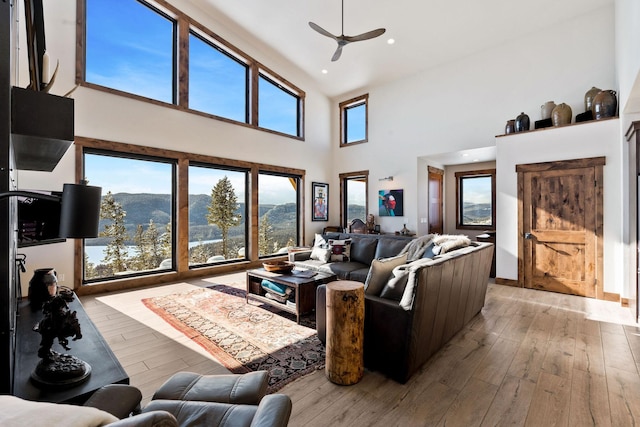 85 Meadows Dr, Whitefish, MT 59937 - living area featuring a high ceiling, a ceiling fan, light wood-style flooring, a mountain view, and recessed lighting
