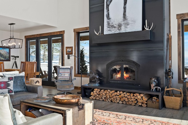 85 Meadows Dr, Whitefish, MT 59937 - living room featuring wood finished floors, a glass covered fireplace, and a chandelier