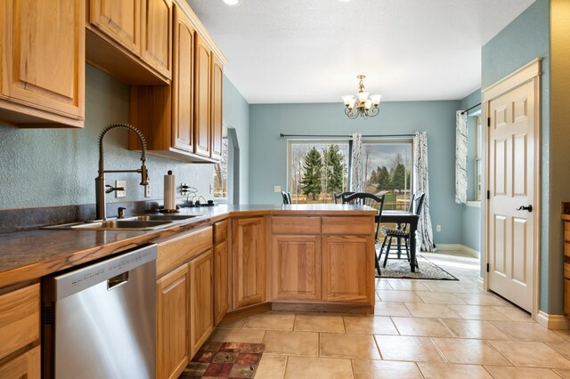 369 Gold Ct, Florence, MT 59833 - kitchen with dishwasher, a sink, a chandelier, a peninsula, and dark countertops