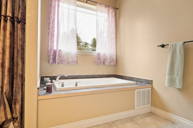 369 Gold Ct, Florence, MT 59833 - bathroom featuring a garden tub, baseboards, and a textured wall