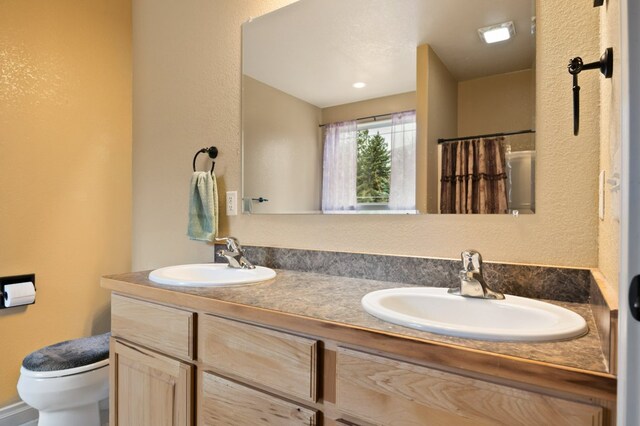 369 Gold Ct, Florence, MT 59833 - bathroom with toilet, double vanity, a shower with curtain, and a textured wall