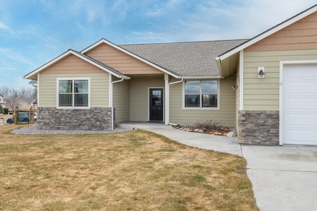 369 Gold Ct, Florence, MT 59833 - view of front of home featuring stone siding, a front yard, roof with shingles, and an attached garage