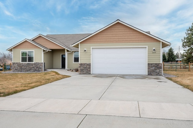 369 Gold Ct, Florence, MT 59833 - view of front facade featuring stone siding, concrete driveway, and an attached garage