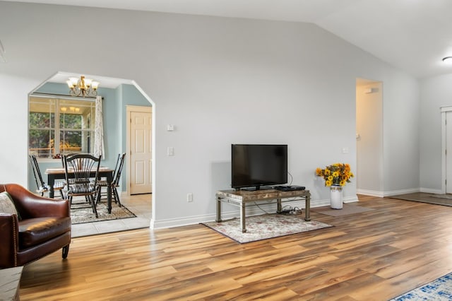 369 Gold Ct, Florence, MT 59833 - living room with lofted ceiling, a chandelier, light wood-type flooring, and baseboards