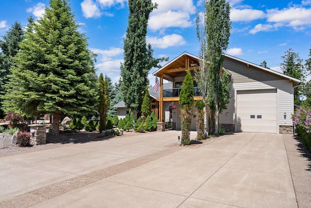 229AND231 Harbor Dr, Bigfork, MT 59911 - view of front facade with a balcony, driveway, stone siding, and a garage