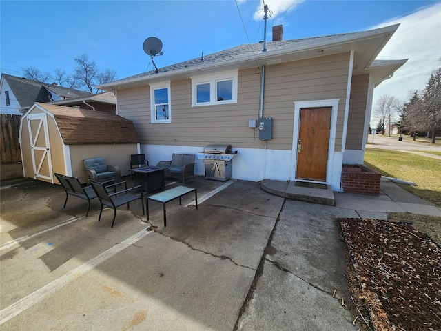 3301 1st Ave N, Great Falls, MT 59401 - rear view of house featuring a patio area, a shed, and a chimney