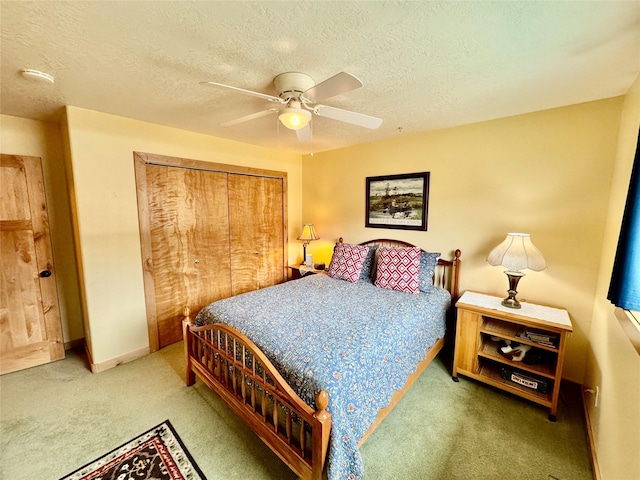 19066 King Rd, Florence, MT 59833 - bedroom with carpet floors, ceiling fan, a closet, and a textured ceiling