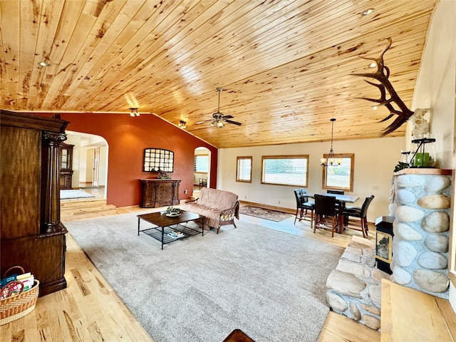 19066 King Rd, Florence, MT 59833 - living area with arched walkways, wood finished floors, vaulted ceiling, and ceiling fan with notable chandelier