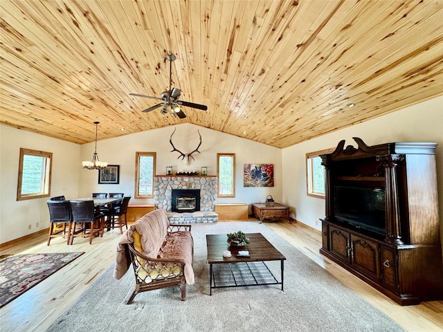 19066 King Rd, Florence, MT 59833 - living room with wooden ceiling, wood finished floors, a stone fireplace, lofted ceiling, and ceiling fan with notable chandelier