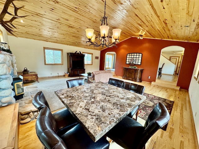19066 King Rd, Florence, MT 59833 - dining space with vaulted ceiling, wood ceiling, a chandelier, wood finished floors, and arched walkways