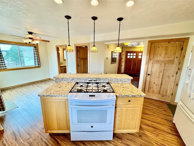19066 King Rd, Florence, MT 59833 - kitchen featuring light brown cabinets, white range with gas cooktop, a textured ceiling, and dark wood finished floors
