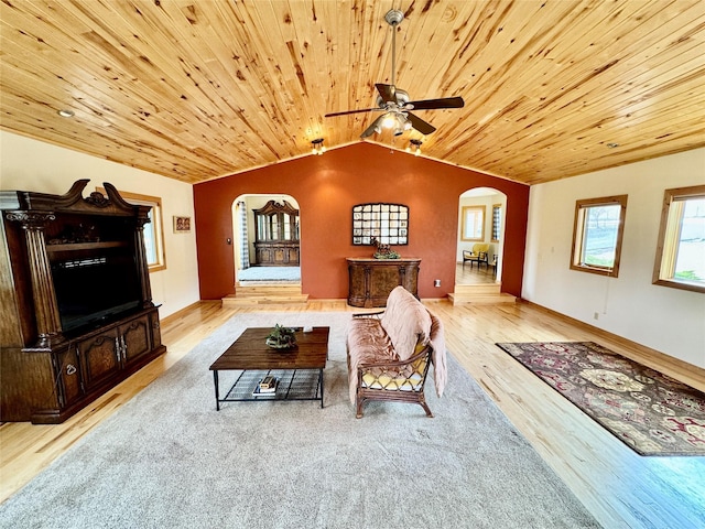 19066 King Rd, Florence, MT 59833 - living room with arched walkways, vaulted ceiling, wooden ceiling, wood finished floors, and a ceiling fan