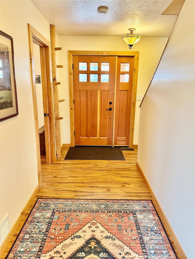 19066 King Rd, Florence, MT 59833 - interior space featuring baseboards, visible vents, a textured ceiling, and wood finished floors
