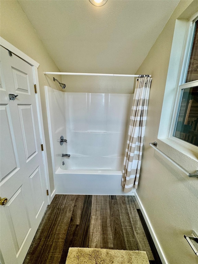 19066 King Rd, Florence, MT 59833 - bathroom featuring vaulted ceiling, wood finished floors, and shower / bath combo