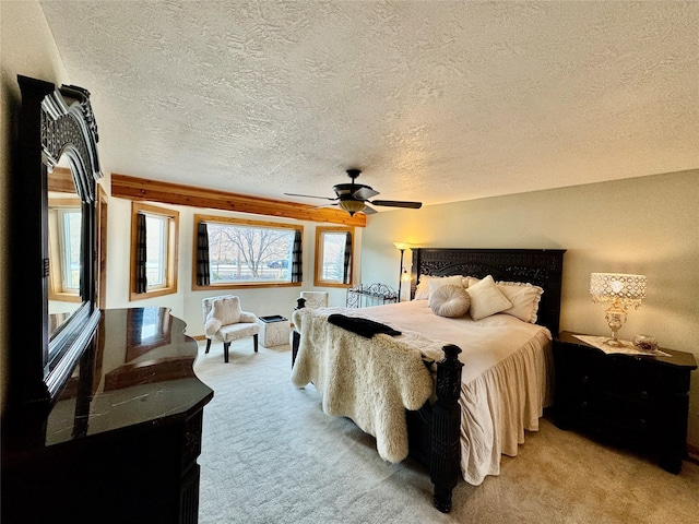 19066 King Rd, Florence, MT 59833 - bedroom featuring light colored carpet, a textured ceiling, and a ceiling fan