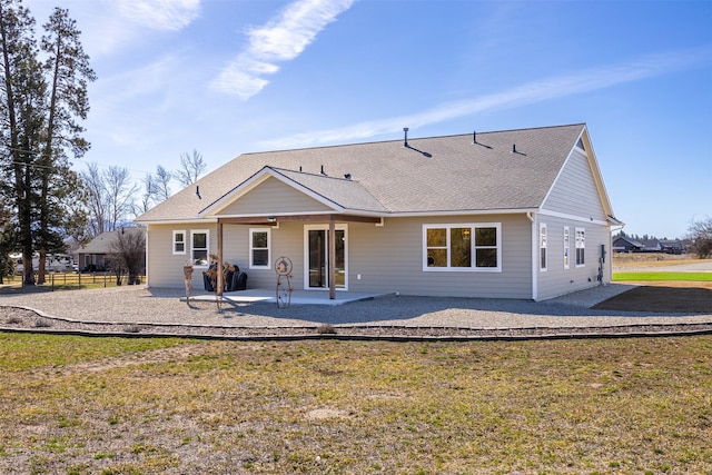 376 Cowboy Ct, Florence, MT 59833 - rear view of property featuring a patio area, a yard, and a shingled roof