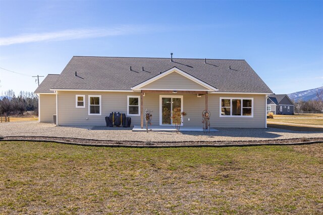 376 Cowboy Ct, Florence, MT 59833 - rear view of property with a patio, a lawn, and a shingled roof