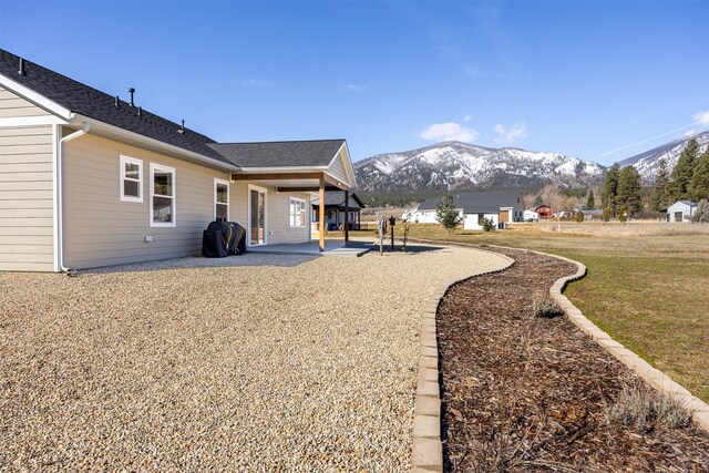 376 Cowboy Ct, Florence, MT 59833 - view of grassy yard featuring a mountain view and a patio area