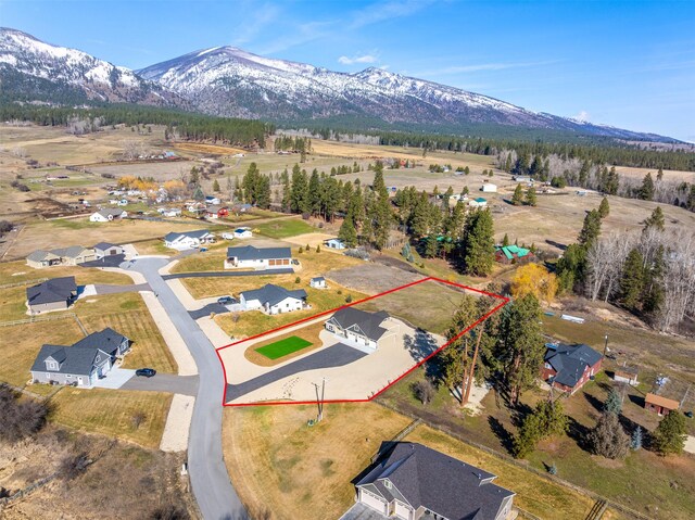 376 Cowboy Ct, Florence, MT 59833 - aerial view of property and surrounding area with property boundaries highlighted and a mountainous background