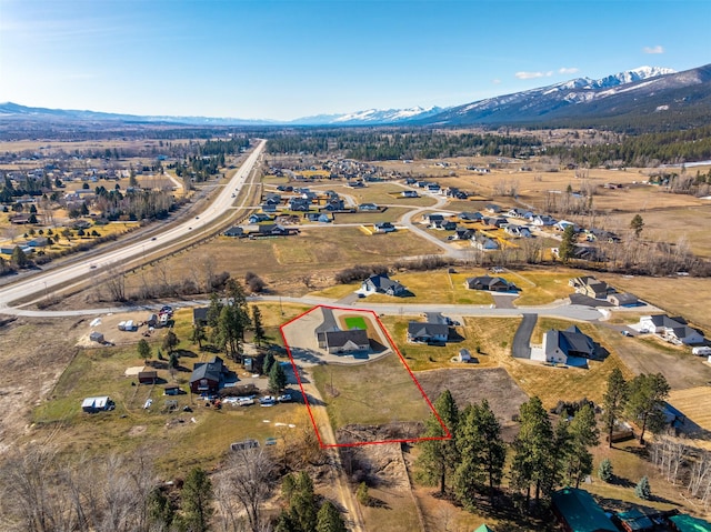 376 Cowboy Ct, Florence, MT 59833 - aerial view of property and surrounding area with property boundaries highlighted and a mountain backdrop