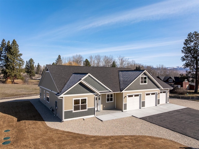 376 Cowboy Ct, Florence, MT 59833 - craftsman house featuring driveway, a garage, and a shingled roof