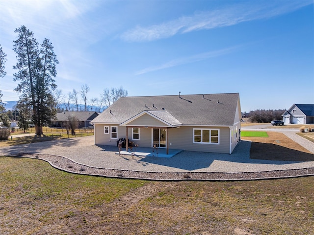 376 Cowboy Ct, Florence, MT 59833 - rear view of property with a patio area, driveway, and a shingled roof