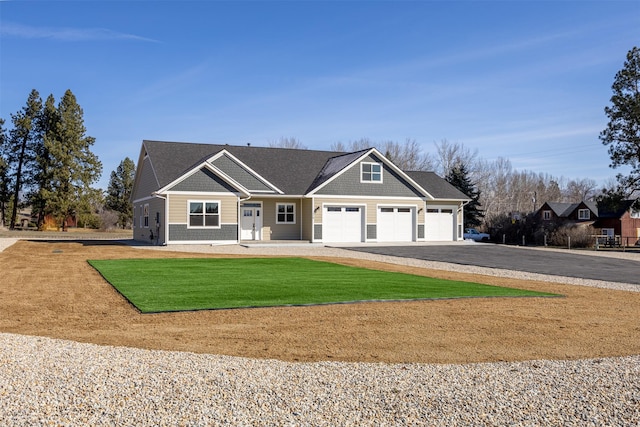 376 Cowboy Ct, Florence, MT 59833 - craftsman-style house featuring a garage, asphalt driveway, and a front yard