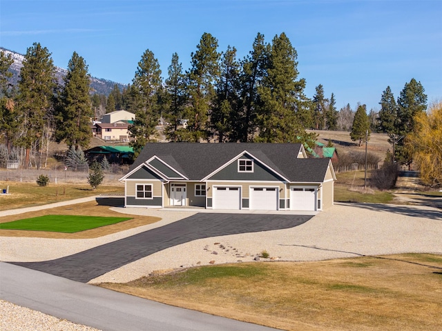 376 Cowboy Ct, Florence, MT 59833 - view of front of property featuring asphalt driveway, a front lawn, and a garage