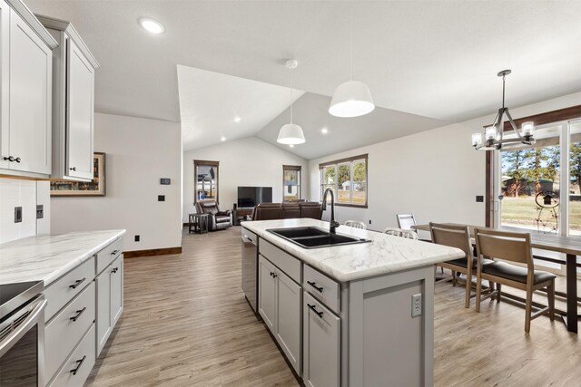 376 Cowboy Ct, Florence, MT 59833 - kitchen featuring lofted ceiling, stainless steel dishwasher, gray cabinetry, range, and a center island with sink