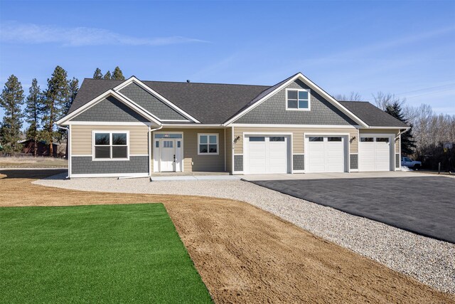 376 Cowboy Ct, Florence, MT 59833 - craftsman house with driveway, an attached garage, and a front lawn