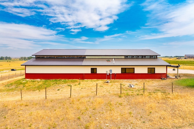 view of side of property featuring an outbuilding, metal roof, and an outdoor structure