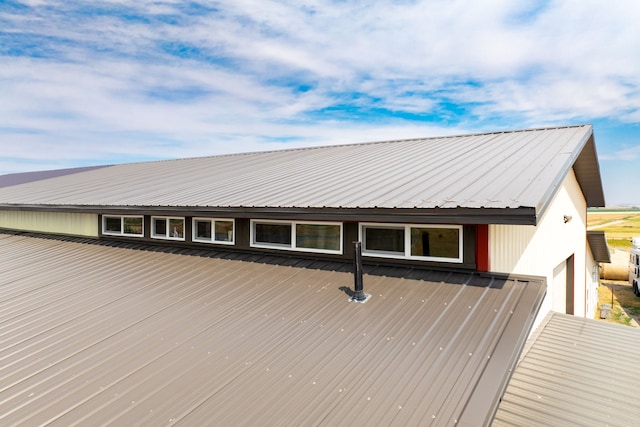 exterior space featuring metal roof and a garage