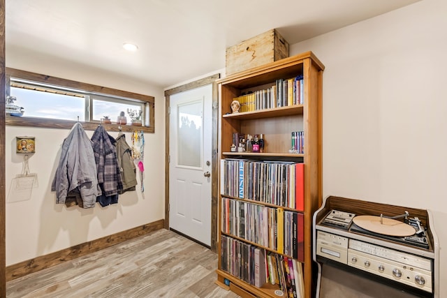 interior space featuring baseboards and light wood-type flooring