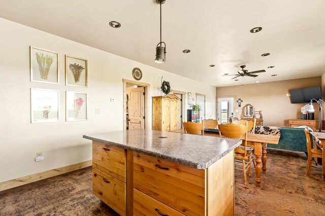 kitchen with baseboards, ceiling fan, recessed lighting, pendant lighting, and a center island