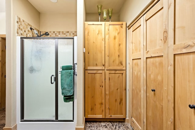 full bathroom featuring a closet and a shower stall