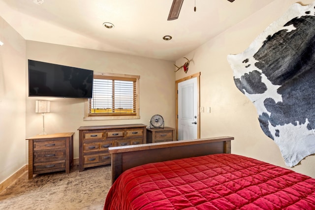 carpeted bedroom featuring baseboards and ceiling fan