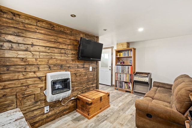 living area featuring heating unit, light wood-type flooring, and recessed lighting