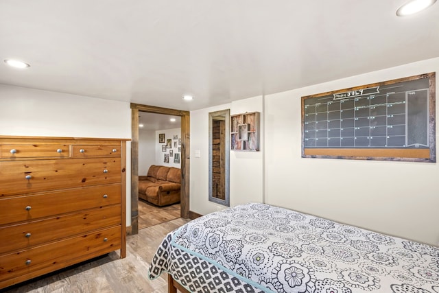 bedroom with recessed lighting and wood finished floors