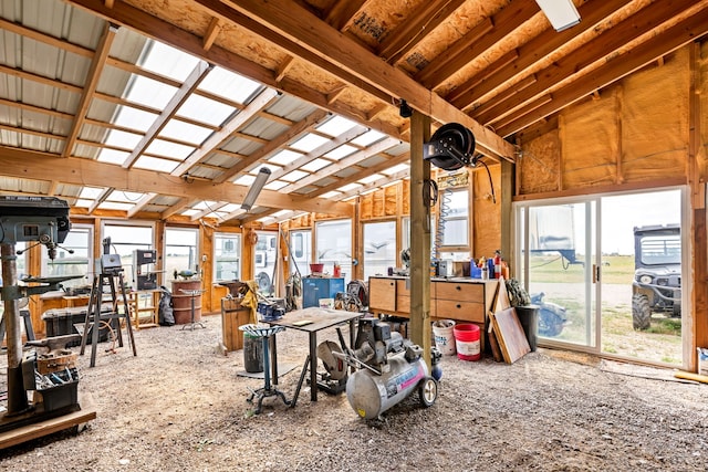 miscellaneous room featuring a workshop area, vaulted ceiling, and plenty of natural light