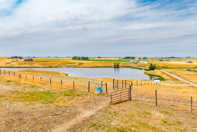 exterior space featuring a gate, a water view, and fence
