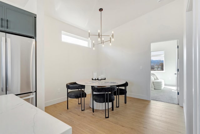 2170 Chuck Wagon Dr Unit A, Missoula, MT 59808 - dining room with a chandelier, light wood-style flooring, and a towering ceiling
