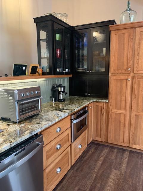 675 Bobcat Ln, Hamilton, MT 59840 - bar featuring dark wood-type flooring, appliances with stainless steel finishes, and a toaster