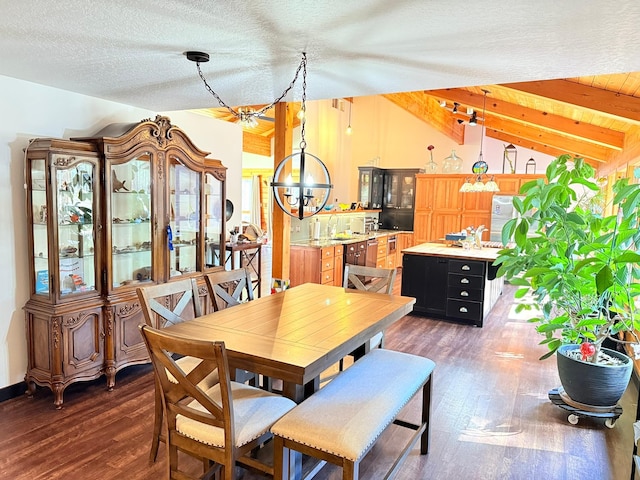 675 Bobcat Ln, Hamilton, MT 59840 - dining space with a textured ceiling, vaulted ceiling with beams, and wood finished floors